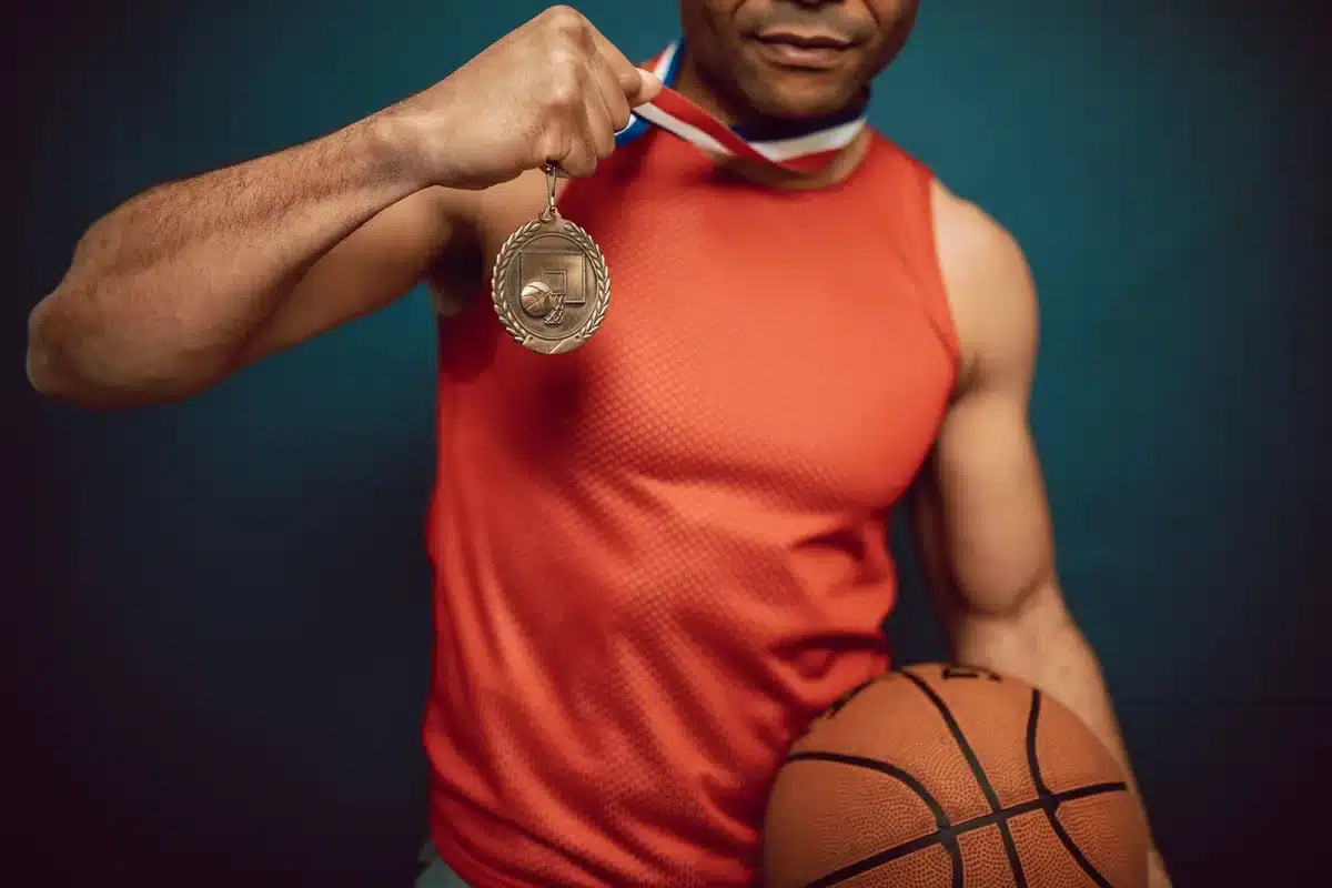 Atleta sosteniendo una medalla de oro bajo la luz del estadio